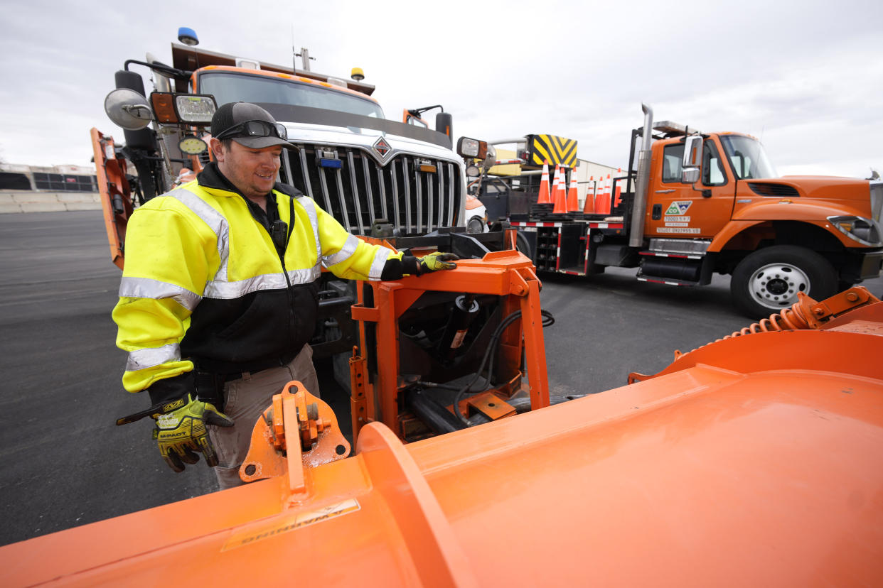 Chris Vigil prepares his snowplow for operation as forecasters predict the first snow of the season to sweep over Front Range communities Thursday, Dec. 9, 2021, at the Colorado Department of Transportation shed in Castle Rock, Colo. This winter more motorists may find themselves stuck on snowy highways or have their travel delayed due to a shortage of snowplow drivers — the latest fallout from a national labor shortage. As the snow begins to fall, states are having trouble finding enough people willing to take the comparatively low-paying jobs that require a Commercial Driver’s License and often entail working at odd hours in dangerous conditions. (AP Photo/David Zalubowski)