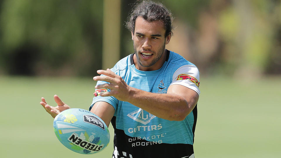 Toby Rudolf is seen here passing a footy during training with the Sharks.