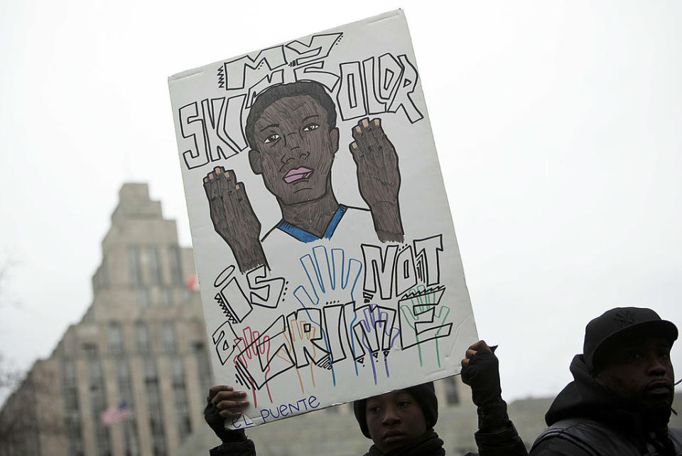 Demonstrator Jihadou Kwantu holds a sign during a demonstration against the city’s “stop and frisk” searches in lower Manhattan near Federal Court March 18, 2013, in New York City. While the Memphis police department eliminated its specialized unit, other cities continue to turn to them. (Photo by Allison Joyce/Getty Images)