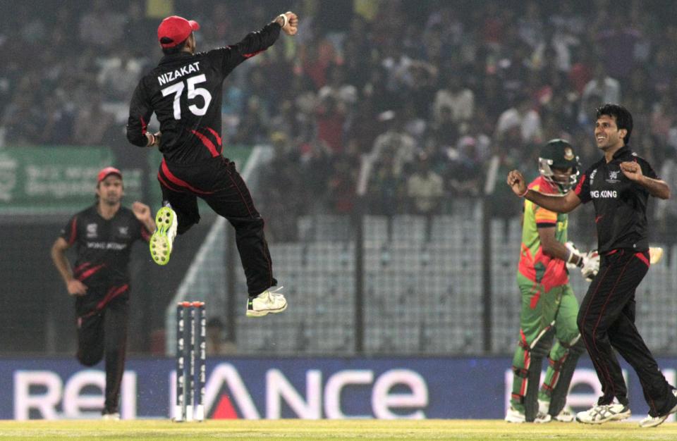 Hong Kong bowler Tanwir Afzal jumps as he celebrates the dismissal of Bangladesh's Tamim Iqbal, during their ICC Twenty20 Cricket World Cup match in Chittagong, Bangladesh, Thursday, March 20, 2014. (AP Photo/Bikas Das)