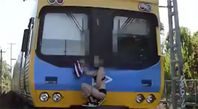 A female train surfed in just her underwear and sneakers as part of a dare. Source: 7News