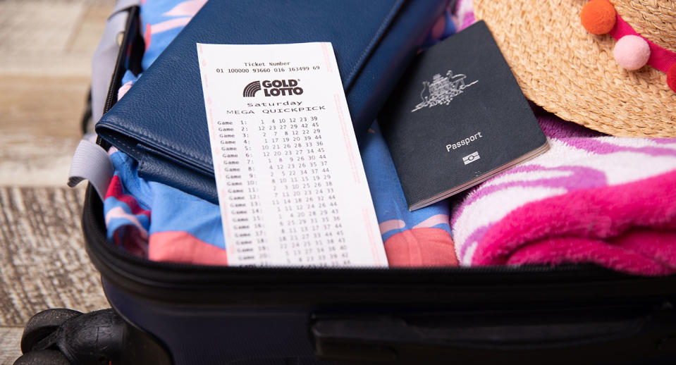A Saturday Gold Lotto ticket sits in a bag next to a beach towel, a hat and a passport.