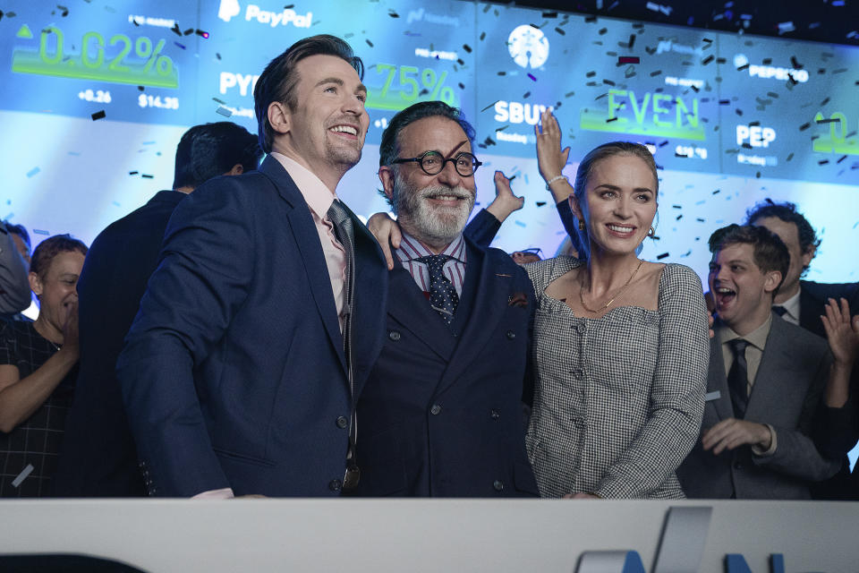 This image released by Netflix shows, from left, Chris Evans, Andy Garcia and Emily Blunt in a scene from "Pain Hustlers." (Brian Douglas/Netflix via AP)