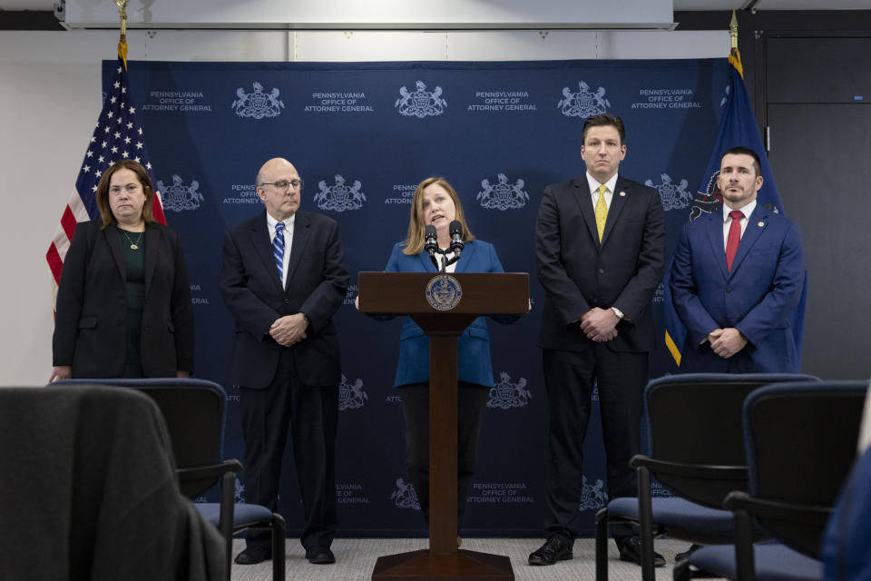 In this photo taken on Feb. 7, 2023, in Harrisburg, Pa., the Pennsylvania Attorney General, Michelle Henry, center, announces child sexual abuse charges against five Pennsylvania men, all members of the Jehovah's Witnesses faith. These filings followed charges brought against four other members of Jehovah's Witnesses congregations across the state and were all a result of an investigative grand jury. (Commonwealth Media Services via AP)