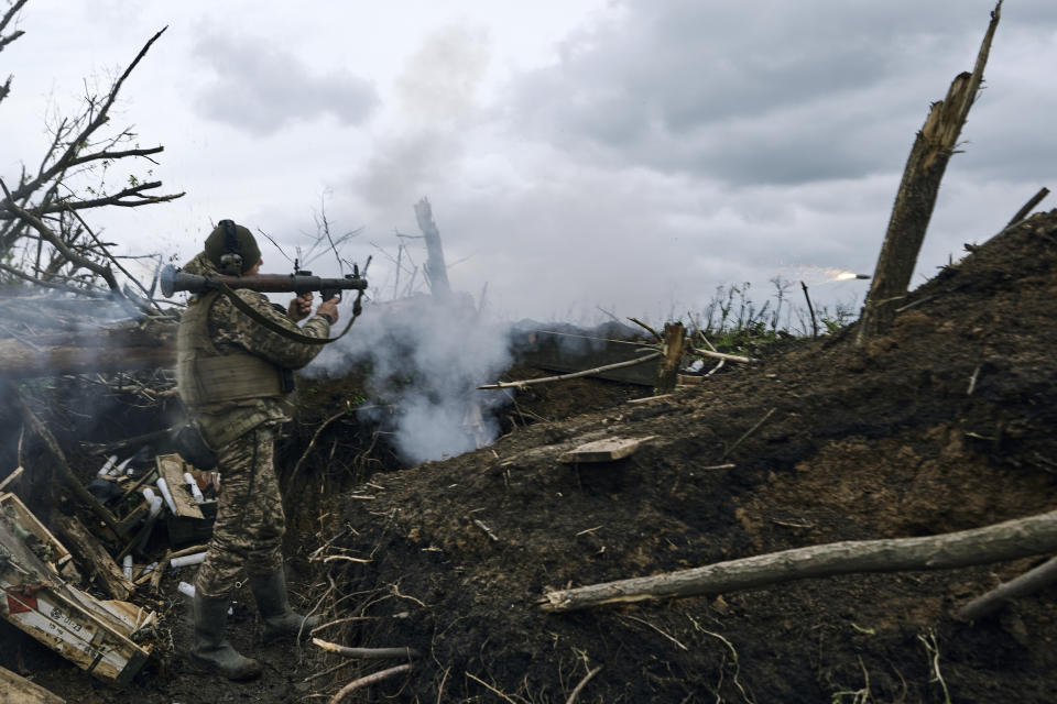 A Ukrainian soldier fires an RPG toward Russian positions at the frontline near Avdiivka, an eastern city where fierce battles against Russian forces have been taking place, in the Donetsk region, Ukraine, Friday, April 28, 2023. (AP Photo/Libkos)