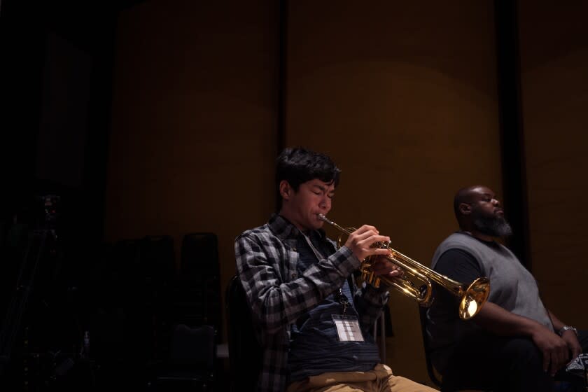 Iosif Tolchinski, 15, is seen practicing a trumpet in a band rehearsal space