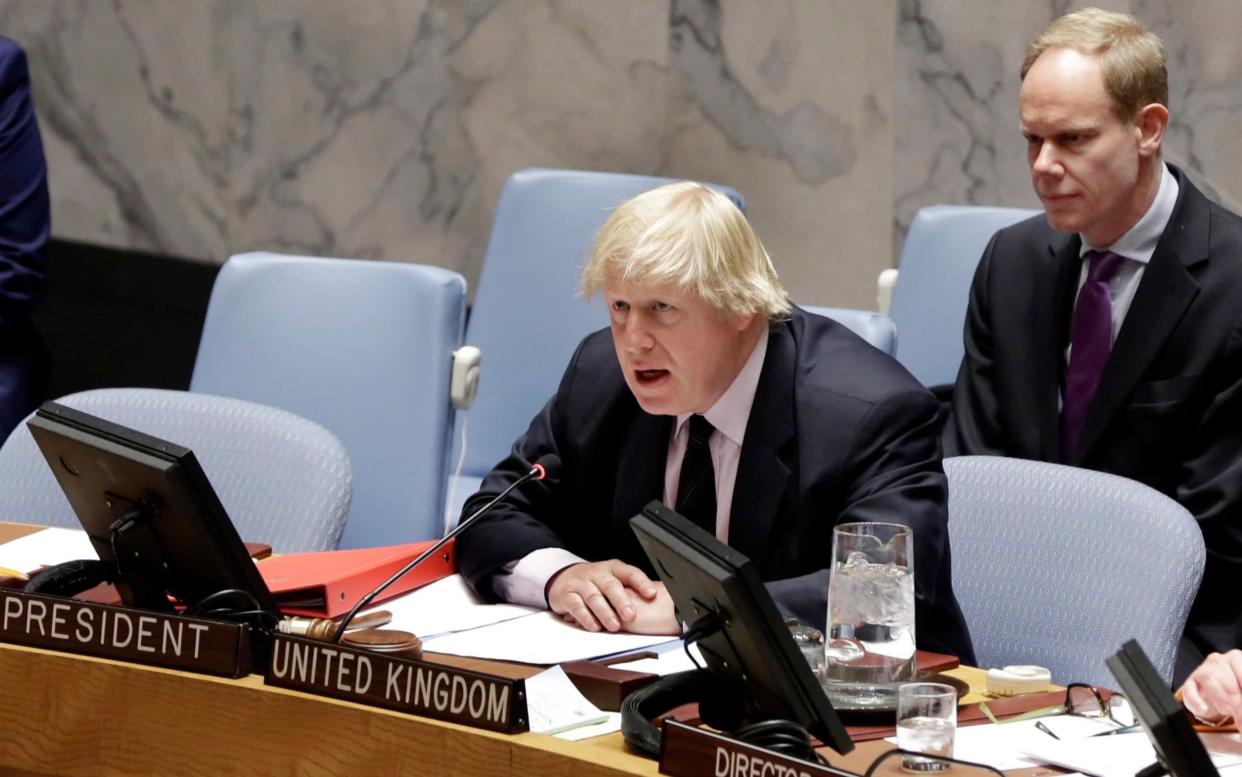 Matthew Rycroft, now the Home Office permanent secretary, looks on as Boris Johnson addresses the United Nations Security Council in 2017 - Richard Drew/AP