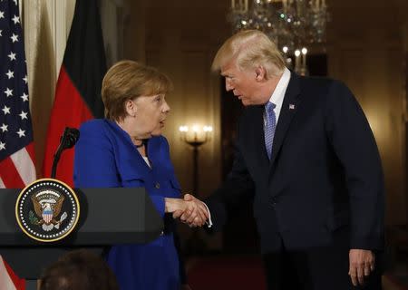 U.S. President Donald Trump greets Germany's Chancellor Angela Merkel during a joint news conference in the East Room of the White House in Washington, U.S., April 27, 2018. REUTERS/Kevin Lamarque