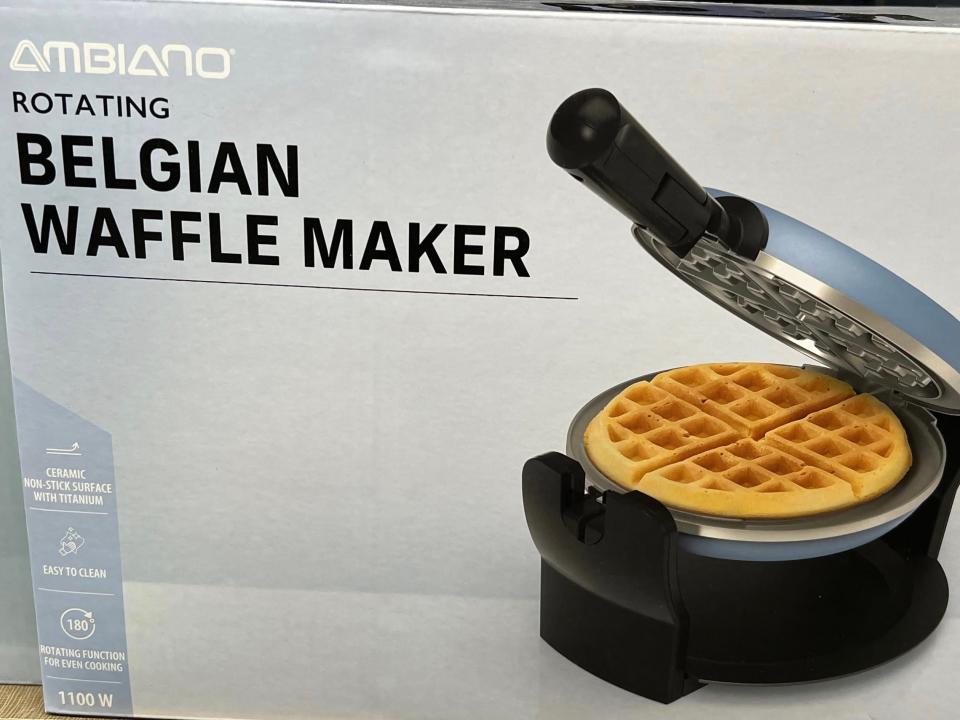 A gray box with a picture of a waffle maker with a golden-brown waffle in it. The box reads Ambiano rotating Belgian waffle maker