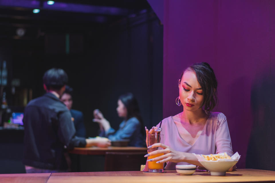 A woman having a drink by herself