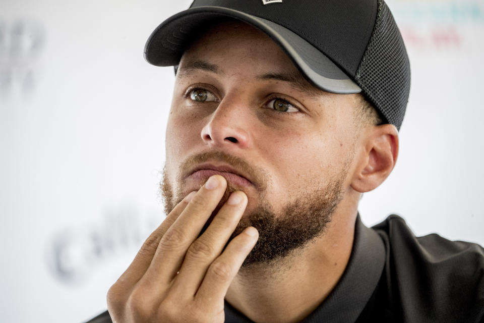 Golden State Warriors guard Stephen Curry attends a news conference at Langston Golf Course in Washington, Monday, Aug. 19, 2019, where Curry announced that he would be sponsoring men's and women's golf teams at Howard University. (AP Photo/Andrew Harnik)