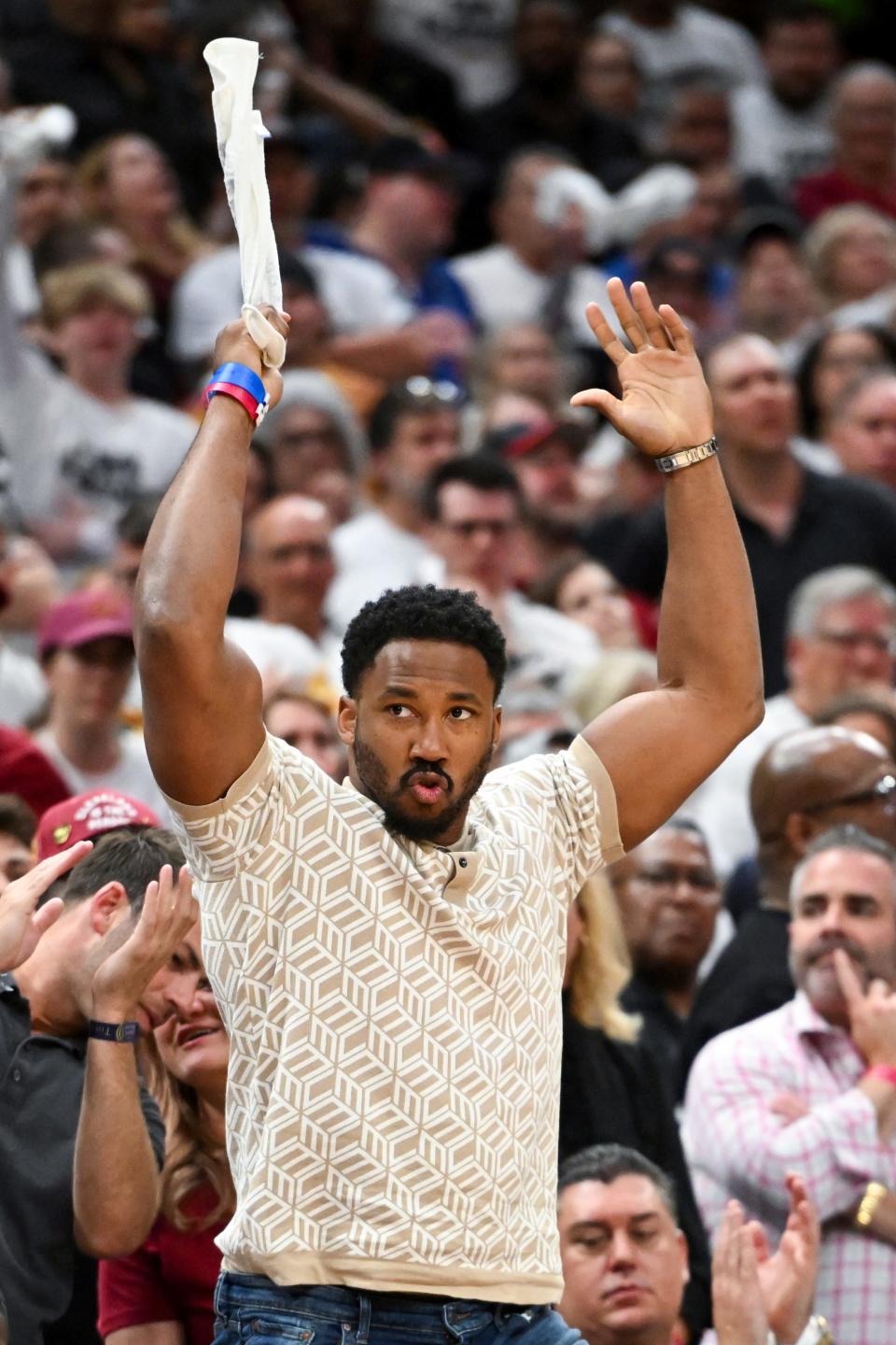 Cleveland Browns defensive end Myles Garrett cheers in the second half during Game 1 in the first round of the NBA basketball playoffs between the New York Knicks and the Cleveland Cavaliers, Saturday, April 15, 2023, in Cleveland. (AP Photo/Nick Cammett)