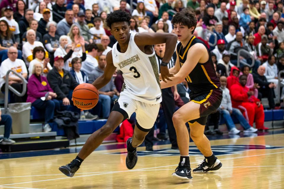 Penn's Markus Burton (3) drives against Chesterton's Sean Kasper (11) during the Penn vs. Chesterton regional championship game Saturday, March 11, 2023 at Michigan City High School.