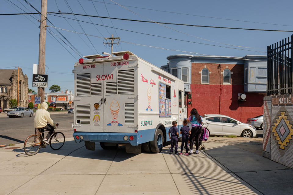 Children wait at an ice cream truck on a street corner in Philadelphia. Child welfare reform advocates have argued for providing parents with more resources to care for their families. (Stephanie Mei-Ling for NBC News and ProPublica)