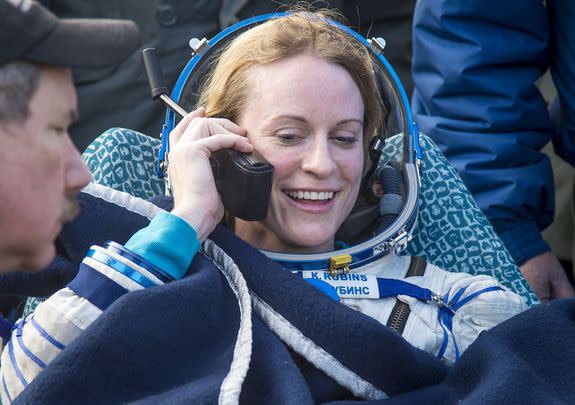 NASA's Kate Rubins talks on the phone after landing.