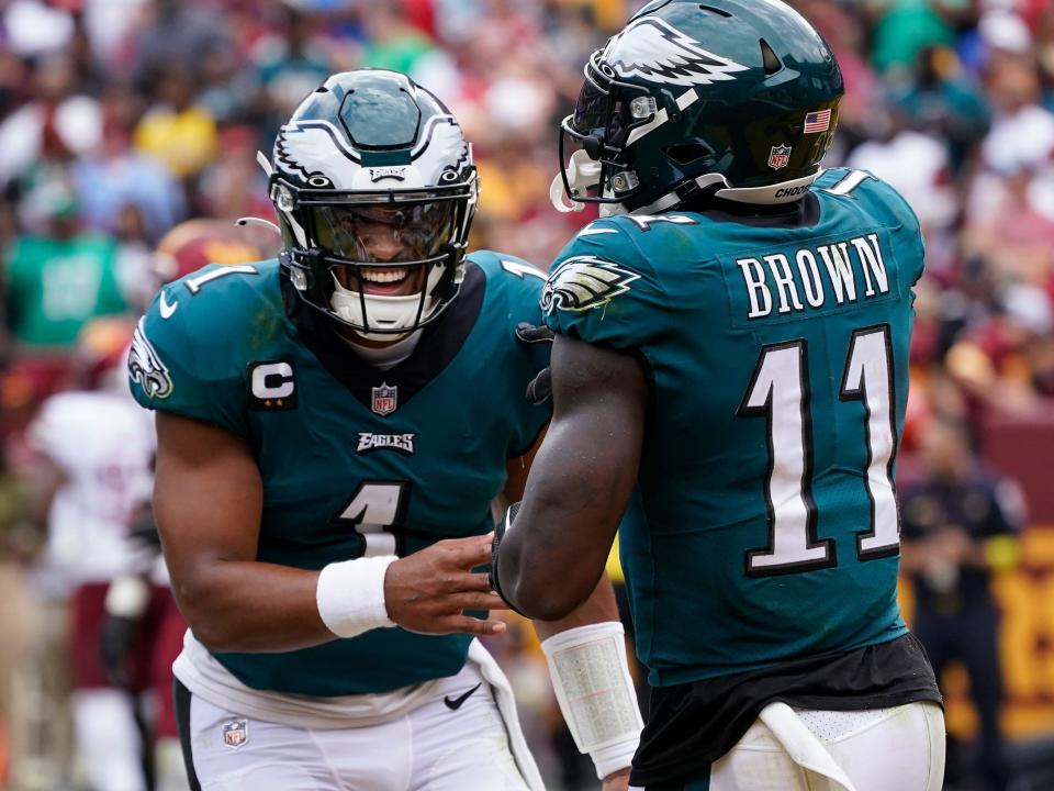 Jalen Hurts and A.J. Brown celebrate a touchdown against the Washington Commanders.