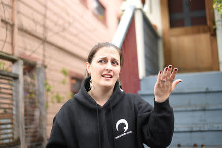Joy Ashe gestures to a building under renovation outside her home in Emeryville, California, United States March 20, 2017. Ashe, who has spoken before the city's planning commission and city council, is concerned about lead and other pollutants from the construction affecting her family. To match Special Report USA-LEAD/CALIFORNIA REUTERS/Noah Berger