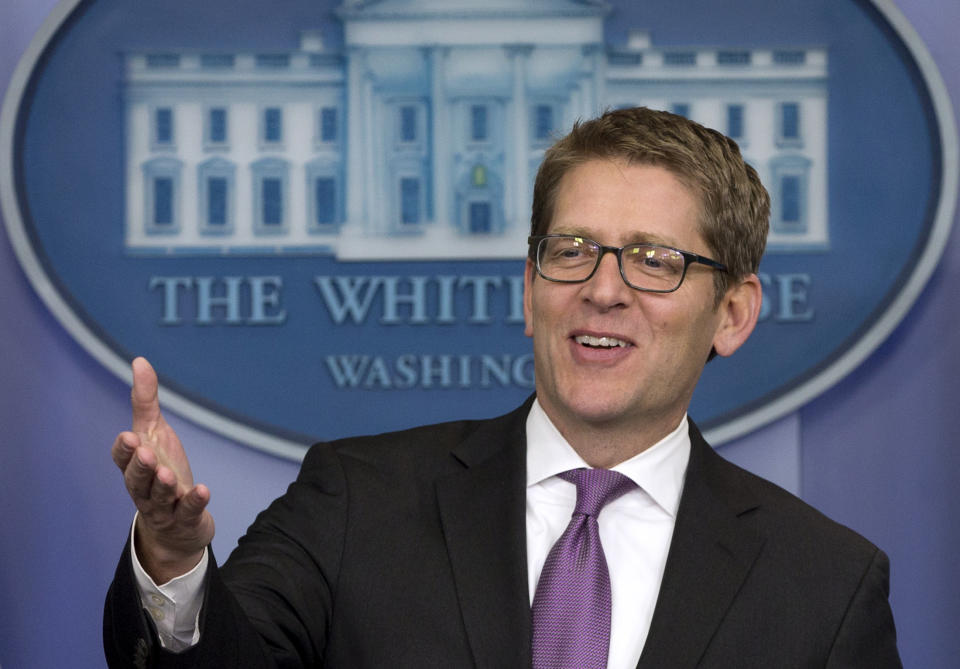 A clean-shaven White House press secretary Jay Carney jokes with reporters as he arrives for his daily news briefing at the White House in Washington, Friday, Jan. 24, 2014. During the briefing Carney discussed President Barack Obama's State of the Union Address, Iran, and other topics. (AP Photo/Carolyn Kaster)