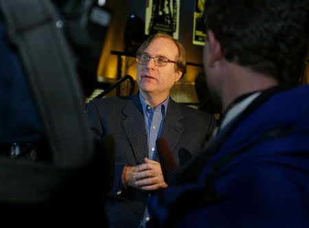 FILE PHOTO: Paul Allen speaks to the media after he announced plans to build a $20 million science fiction museum adjacent to his Experience Music Project, in Seattle, Washington, April 17, 2003. REUTERS/Anthony P. Bolante/File Photo