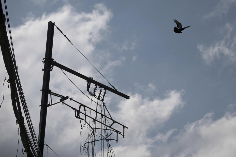 Tangled cables hang over the collapsed elevated section of subway Line 12, in Mexico City, Wednesday, June 16, 2021. A preliminary report released Wednesday by the Norwegian certification firm DNV, into the collapse of the Mexico City elevated subway line that killed 26 people, placed much of the blame on poor welds in studs that joined steel support beams to a concrete layer supporting the track bed. (AP Photo/Fernando Llano)