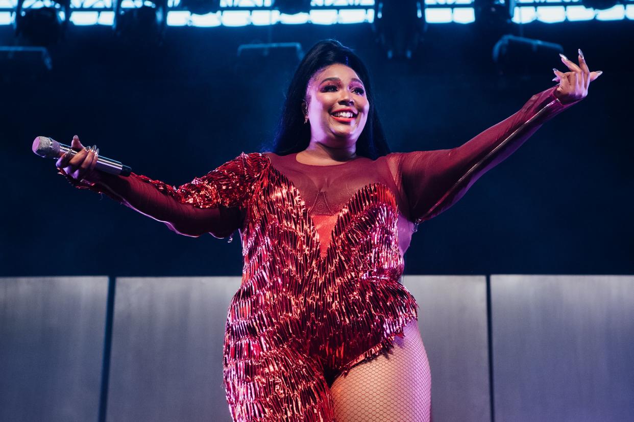 Lizzo on stage, performing. 