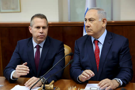 FILE PHOTO: Israeli Prime Minister Benjamin Netanyahu (R) sits next to Israeli Public security Minister Gilad Erdan during the weekly cabinet meeting in Jerusalem April 10, 2016. REUTERS/Gali Tibbon/Pool/File photo