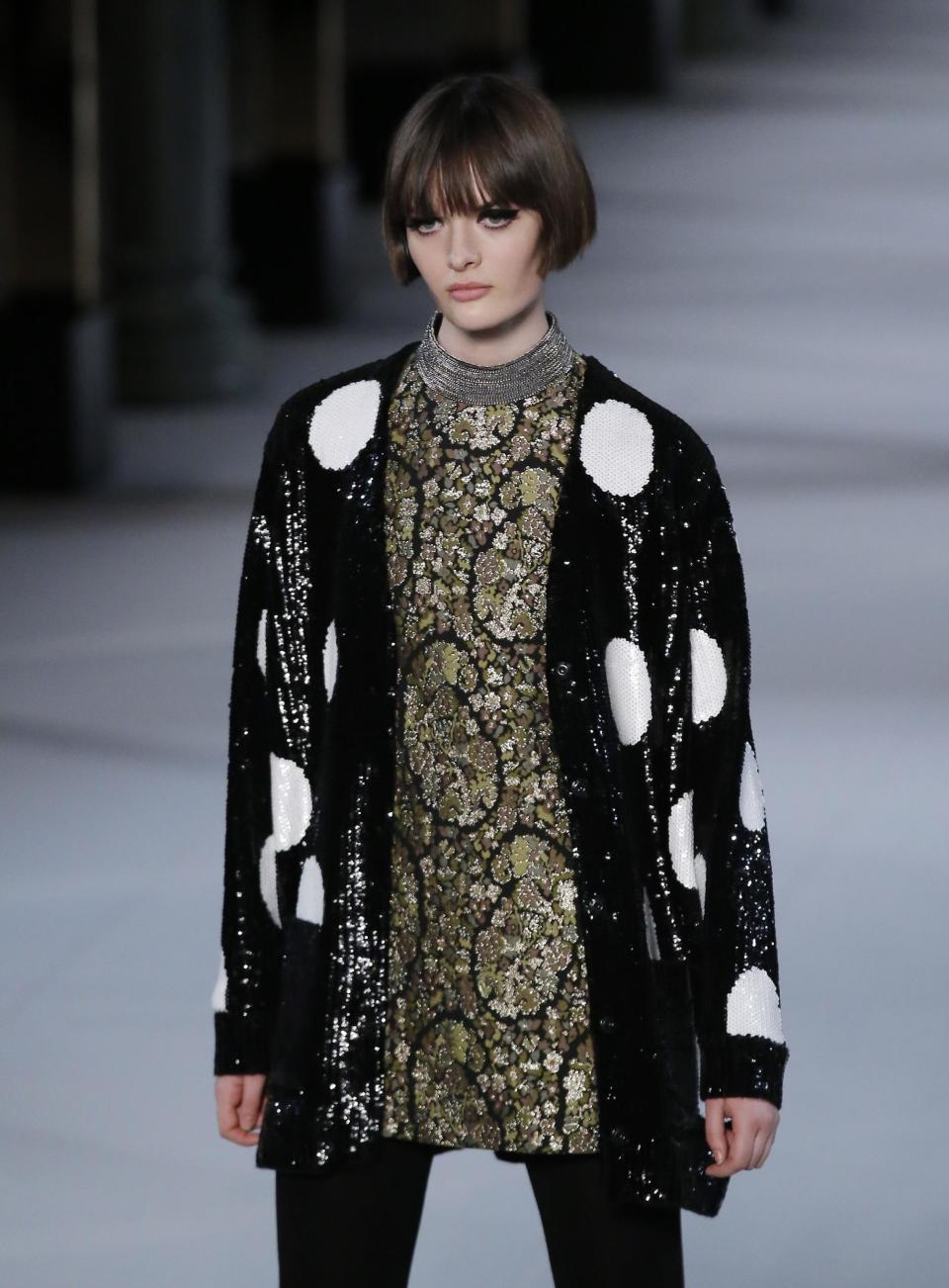 A model wears creations by French fashion designer Hedi Slimane for St Laurent ready-to-wear fall/winter 2014-2015 fashion collection presented in Paris, Monday, March 3, 2014. (AP Photo/Michel Euler)