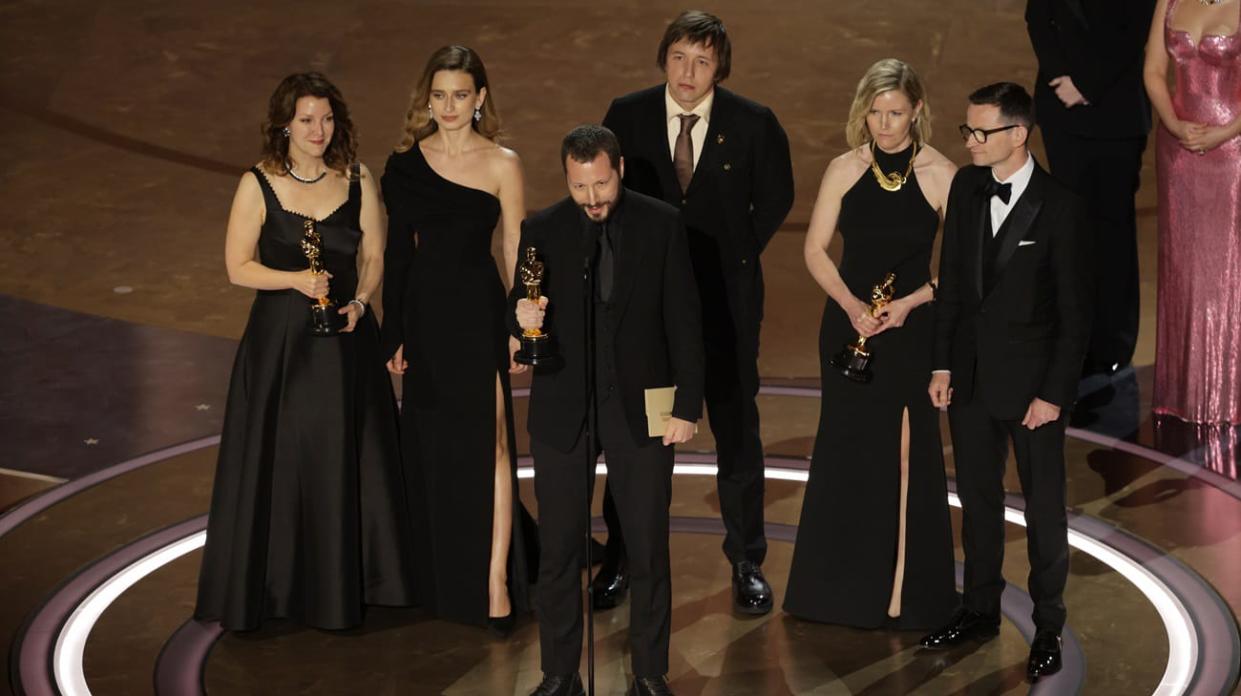 Mstyslav Chernov, center, during the live telecast of the 96th Annual Academy Awards. Photo: Getty Images