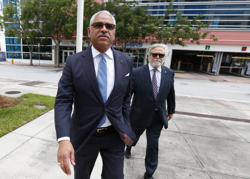 Carnival Corp. CEO Arnold Donald, left, and chairman Micky Arison walk to federal court, Wednesday, Oct. 2, 2019, in Miami. Top Carnival Corp. executives are back in court to explain what the world's largest cruise line is doing to reduce ocean pollution. (AP Photo/Wilfredo Lee)