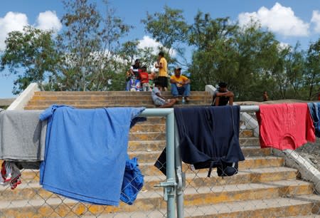 Central American migrants are seen near the Gateway International Bridge as seen from Matamoros