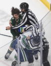 Minnesota Wild's Ryan Hartman (38) and Vancouver Canucks' J.T. Miller (9) fight during second-period NHL hockey game action in Edmonton, Alberta, Thursday, Aug. 6, 2020. (Jason Franson/The Canadian Press via AP)