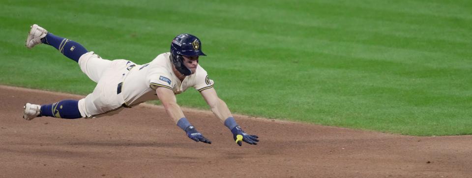 Milwaukee Brewers outfielder Sal Frelick dives after hitting a double during the fourth inning of their wild-card playoff game against the New York Mets.