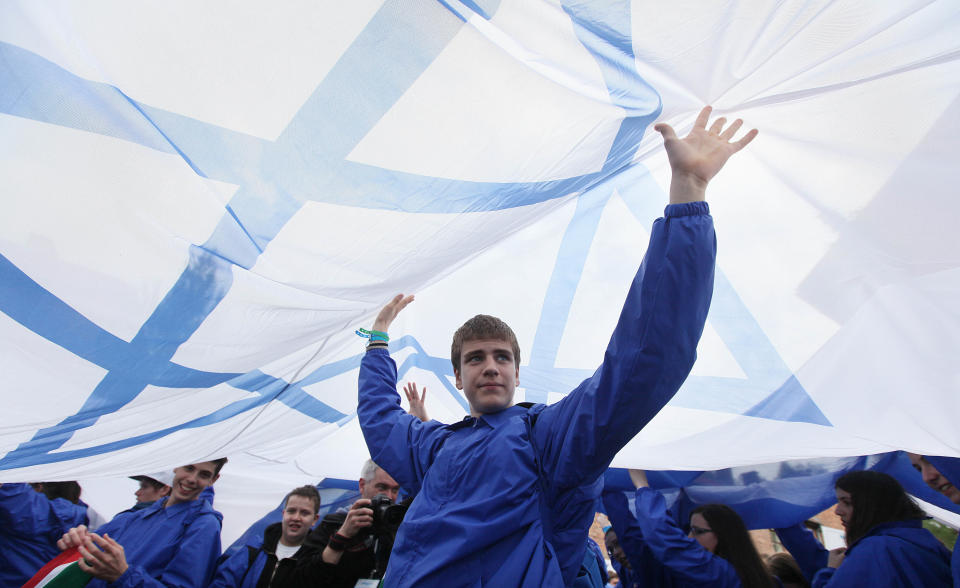 Participants from Israel carry an Israel flag as they attend the 'March of the Living' from the former German Nazi death camp in Oswiecim, Poland, on Monday, April 28, 2014, in memory of some 6 million Jews killed during the Holocaust. This year, the march honors some 430,000 Hungarian Jews killed in Birkenau gas chambers in 1944. ( AP Photo/Czarek Sokolowski)