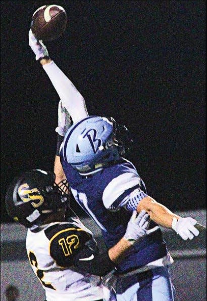 Bartlesville receiver A.J. Archambo, right, goes high to spear a catch for a touchdown during the 2016 season.