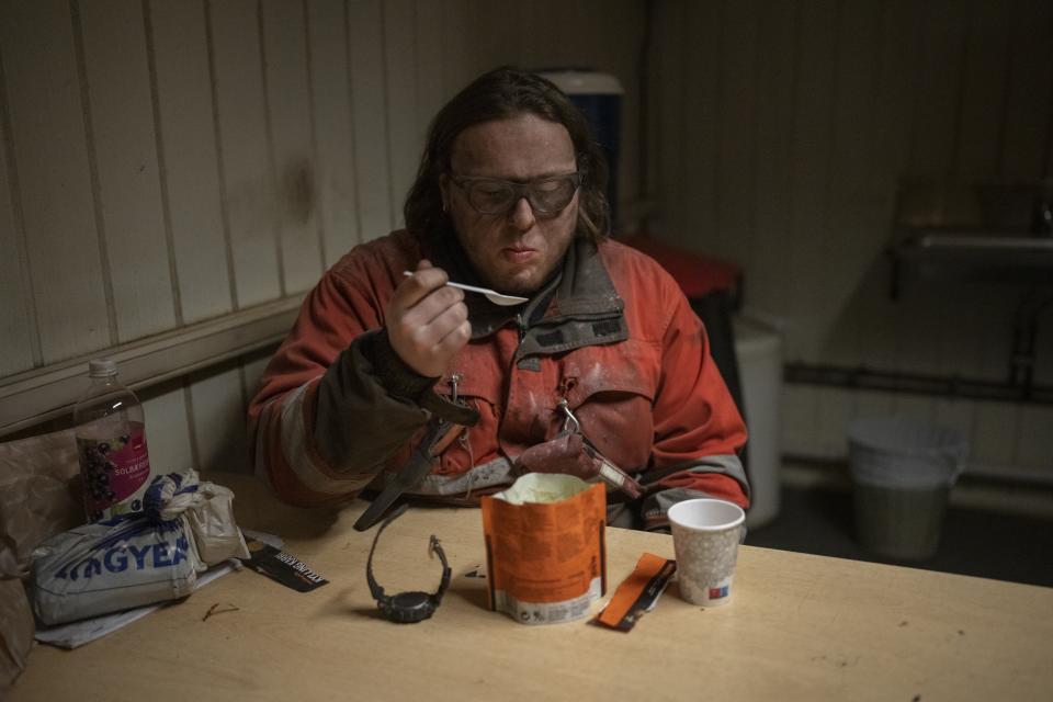 Coal miner Elias Hagebo, 18, eats in the break room at the bottom of the Gruve 7 coal mine in Adventdalen, Norway, Monday, Jan. 9, 2023. The last Norwegian coal mine in Svalbard – an archipelago that's one of the world's fastest warming spots – was slated to close this year and only got a reprieve until 2025 because of the energy crisis driven by the war in Ukraine. (AP Photo/Daniel Cole)