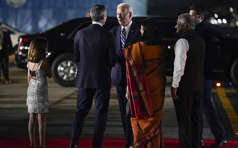 President Biden greets people, including U.S. Ambassador to India Eric Garcetti and his daughter Maya, left, after arriving at Indira Gandhi International Airport