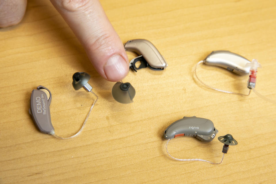 Sterling Sheffield, an assistant professor of Speech, Language, and Hearing Sciences at the University of Florida, shows over-the-counter hearing aids Wednesday, Nov. 30, 2022, in Gainesville, Fla. OTC hearing aids started hitting the market in October afterthe FDA approved themfor adults with mild-to-moderate hearing loss, and Sheffield has been testing them. (AP Photo/Alan Youngblood)