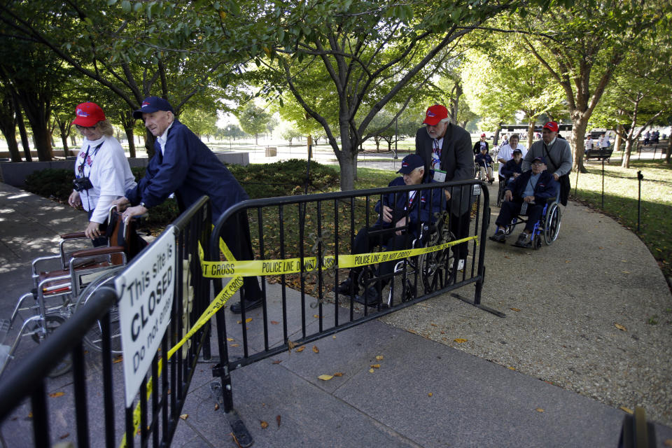 A group of WWII veterans from Montana go around the barricades to the Franklin Delano Roosevelt Memorial, Monday, Oct. 14, 2013, in Washington. (AP Photo/Alex Brandon)