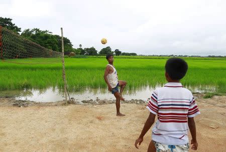 Men plays Chinlone, the traditional sport of Myanmar, at Kanhla village, an area to be included in the New City Project, outside Yangon August 30, 2014. REUTRS/Soe Zeya Tun