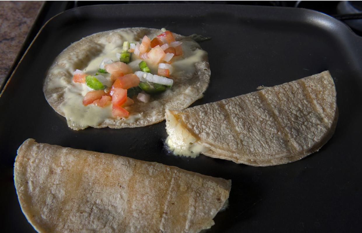 quesadilla with pico de gallo or salsa bandera in a pan, a traditional mexican snack