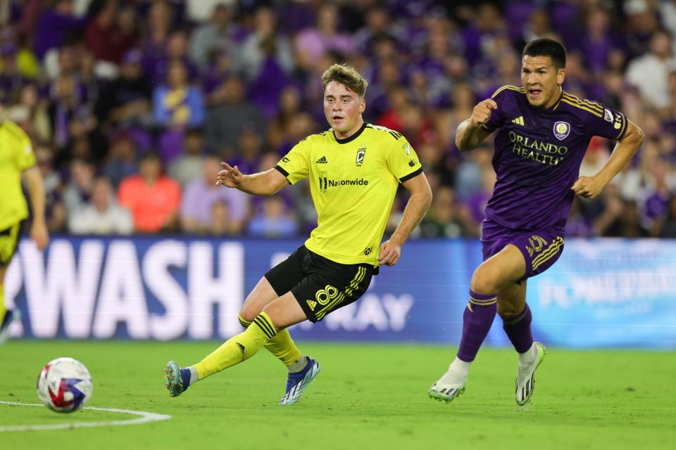 Nov 25, 2023; Orlando, Florida, USA; Columbus Crew midfielder Aidan Morris (8) passes the ball as Orlando City midfielder César Araújo (5) defends during the first half in a MLS Cup Eastern Conference Semifinal match at Exploria Stadium. Mandatory Credit: Nathan Ray Seebeck-USA TODAY Sports