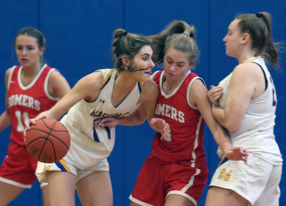 Mahopac's Lauren Bebermen (11) tries to get around Somers Sydney Ingraham (3) during girls basketball playoff action at Mahopac High School Feb. 18, 2023.  