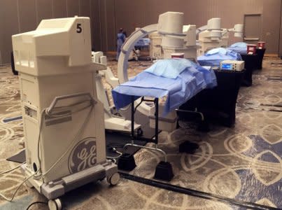 Body parts lie under sheets in an event room during a pain medicine symposium at the Hyatt Regency Jersey City on the Hudson in Jersey City, New Jersey, U.S., October 29, 2017.      Picture taken October 29, 2017.     To match Special Report USA-BODIES/HOTELS     REUTERS/Elizabeth Culliford