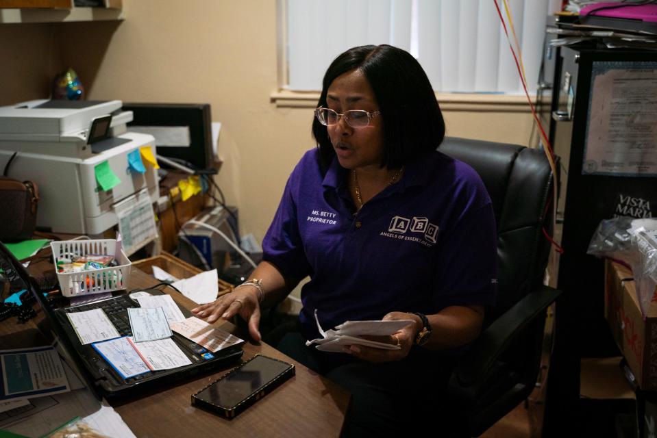 Owner and director Betty Henderson, 51, looks through letters and checks that were donated by strangers inside her office at Angels of Essence Day Care in Detroit on Jan. 19, 2023. 'I write a thank you letter to everyone,' said Henderson. 'They don't even know me. I ask myself, how can I ever repay them?'