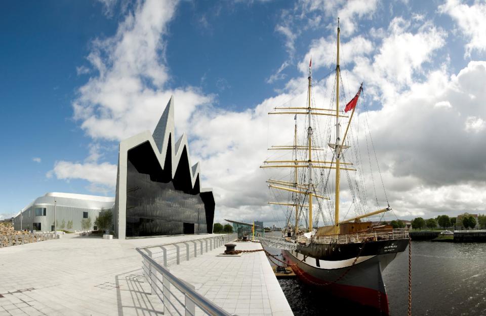 This undated photo provided by Glasgow City Marketing Bureau shows the Riverside Museum on the banks of the Clyde River in Glasgow, Scotland. Its exhibits include a sailing ship permanently moored outside the museum. The museum, which is free to visit, was designed by renowned architect Zaha Hadid. (AP Photo/Glasgow City Marketing Bureau)