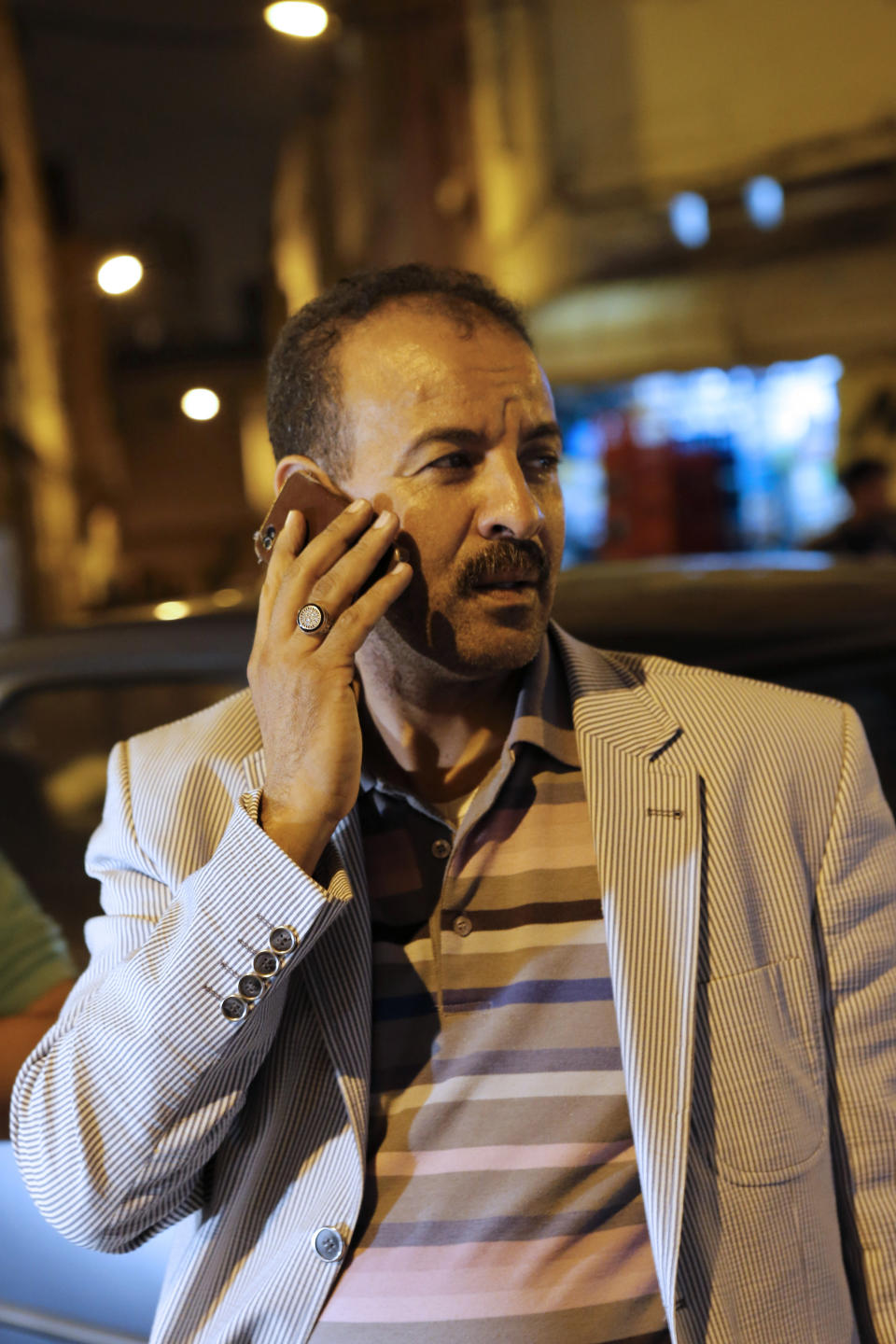 This Wednesday April 30, 2014 photo shows Moroccan police officer Abdelillah Saouti speaking with his cell phone during a patrol in Casablanca, Morocco. Never has a police officer had as much praise by Moroccans. Abdelillah Saouti has become a star in Casablanca after he cleaned several dangerous neighborhoods, and 21,000 fans have even created a page for him on Facebook.(AP Photo / Abdeljalil Bounhar)
