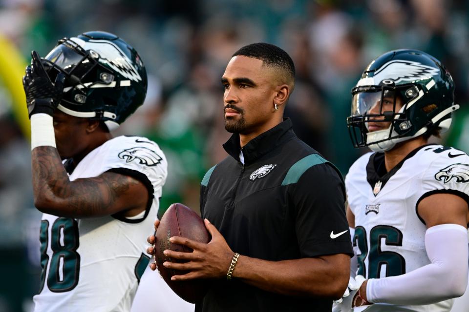 Philadelphia Eagles quarterback Jalen Hurts, center, watches warm-ups before a preseason football game against the Cleveland Browns on Thursday, Aug. 17, 2023, in Philadelphia.