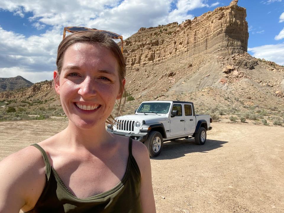 The author in front of her rental car in Moab, Utah.