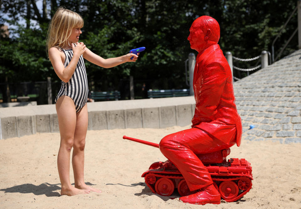 A child points a water pistol at a statue of Russian President Vladimir Putin riding a tank by French artist James Colomina in a playground in Central Park in Manhattan, New York City, U.S., August 2, 2022. / Credit: ANDREW KELLY / REUTERS