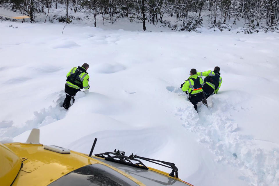 Police wade through waist-high snow in their search for the hiker. Source: AAP